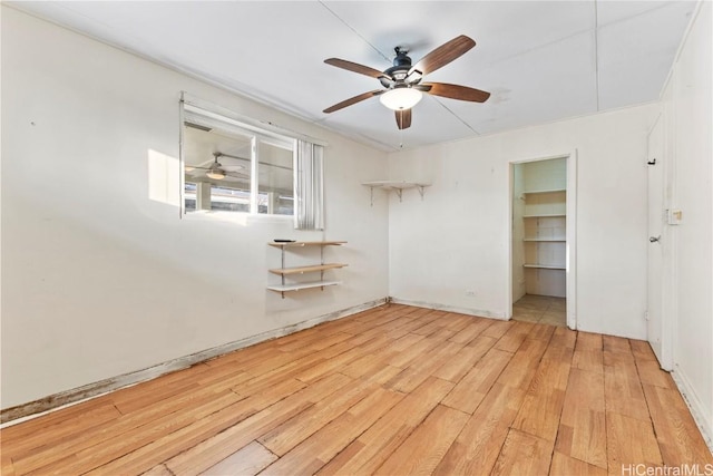 spare room with light wood finished floors and ceiling fan