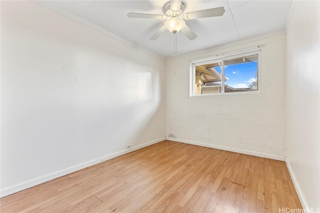 spare room with light wood-type flooring, baseboards, and ceiling fan