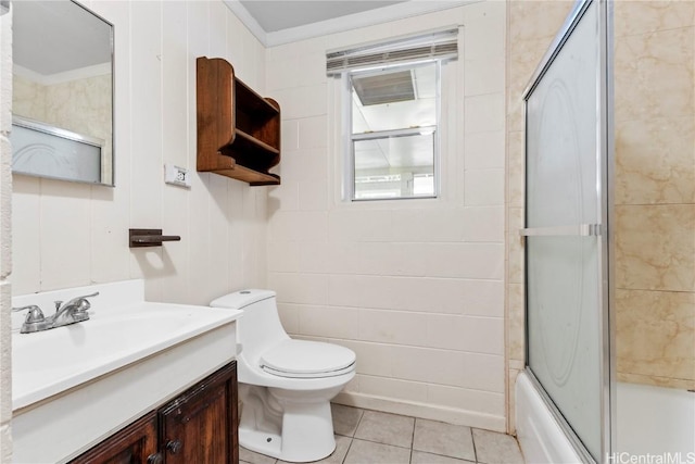 bathroom with vanity, bath / shower combo with glass door, ornamental molding, tile patterned flooring, and toilet