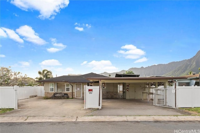 single story home featuring a carport, a gate, fence private yard, and a mountain view