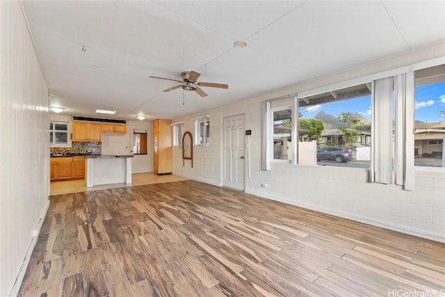 unfurnished living room with light wood finished floors and ceiling fan