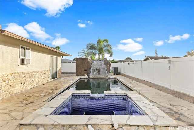 view of pool with a patio area, a fenced backyard, and central AC