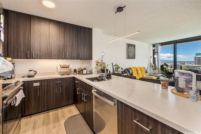 615 Keawe St Unit 1905, Honolulu, HI 96813 - kitchen featuring appliances with stainless steel finishes, a textured ceiling, open floor plan, light countertops, and dark brown cabinetry