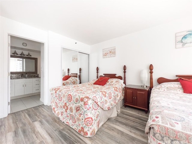 201 Ohua Ave Unit 1108, Honolulu, HI 96815 - bedroom featuring ensuite bath, light wood-type flooring, and a closet