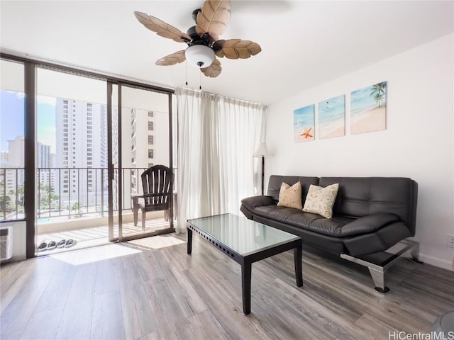 201 Ohua Ave Unit 1108, Honolulu, HI 96815 - living room with a wall of windows, a view of city, wood finished floors, and a ceiling fan
