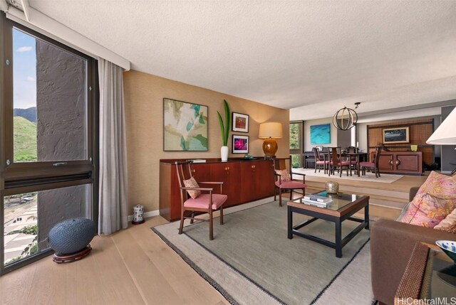 living area with a textured ceiling and wood finished floors