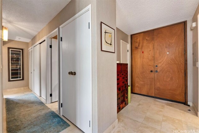 hallway with a textured ceiling