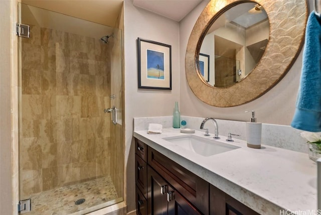 full bath with a stall shower and vanity