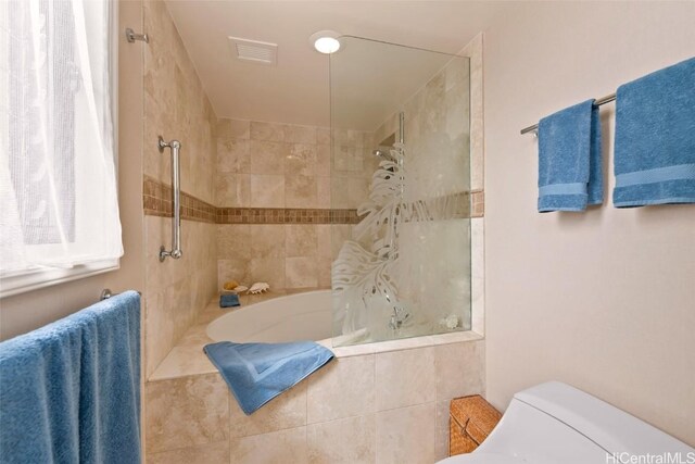 full bathroom with toilet, visible vents, and tiled shower