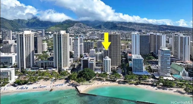 view of city featuring a view of the beach and a water and mountain view