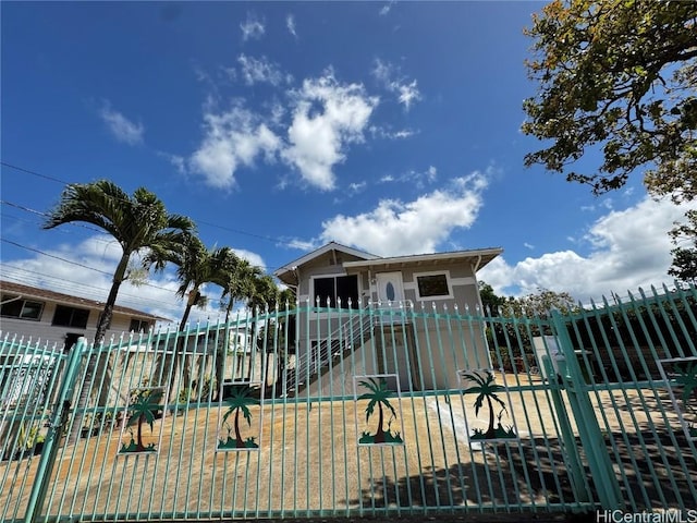 view of front of property featuring a gate and fence