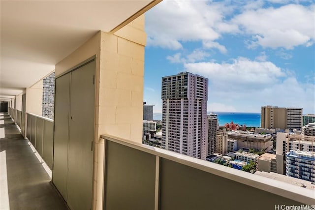 balcony featuring a view of city and a water view