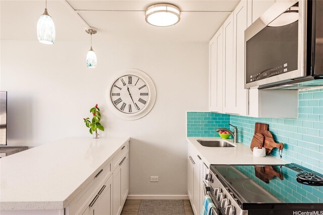 2211 Ala Wai Blvd Unit 3114, Honolulu, HI 96815 - kitchen featuring appliances with stainless steel finishes, a peninsula, backsplash, a sink, and baseboards
