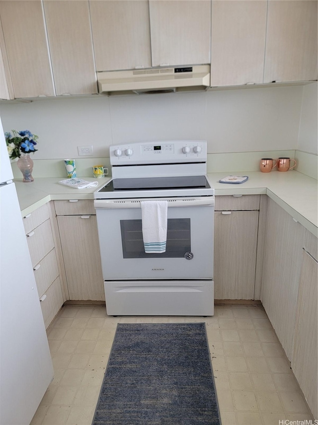 kitchen with light floors, white appliances, light brown cabinets, and under cabinet range hood