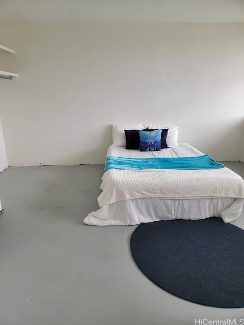 bedroom featuring concrete floors