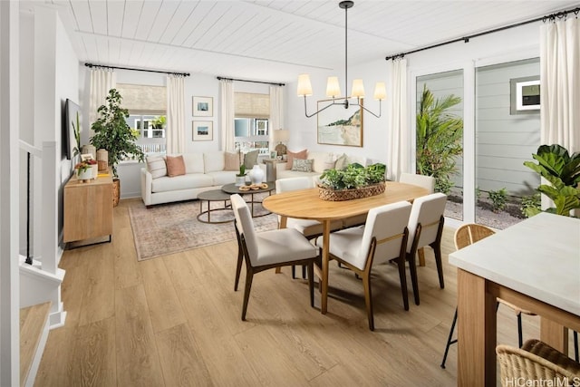 dining room with wood ceiling, light wood-type flooring, and a chandelier