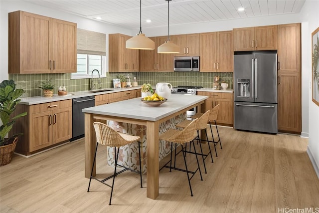 kitchen featuring stainless steel appliances, light countertops, and a sink