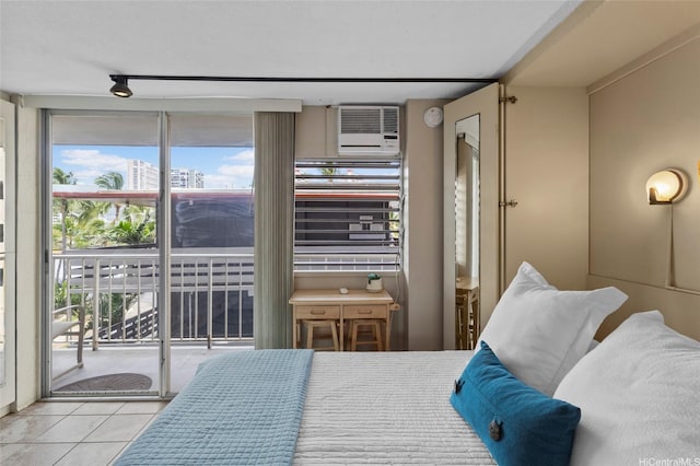bedroom featuring access to exterior, tile patterned flooring, and a wall unit AC