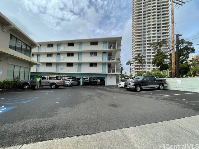 2873 S King St Unit 203, Honolulu, HI 96826 - view of building exterior with uncovered parking