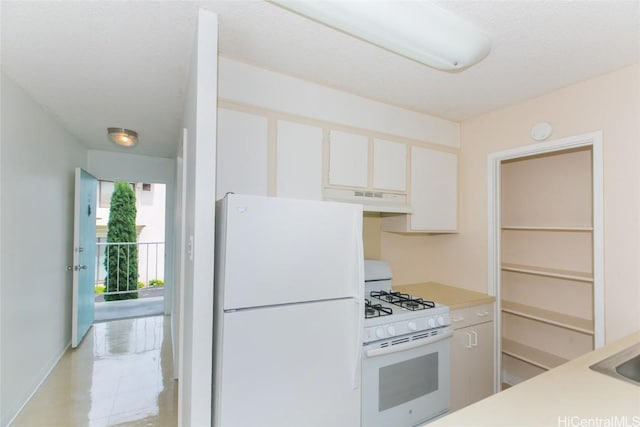 2873 S King St Unit 203, Honolulu, HI 96826 - kitchen with under cabinet range hood, white cabinets, white appliances, and light countertops