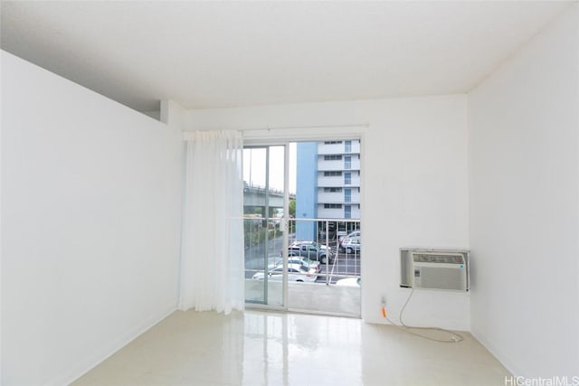 2873 S King St Unit 203, Honolulu, HI 96826 - empty room featuring an AC wall unit and baseboards