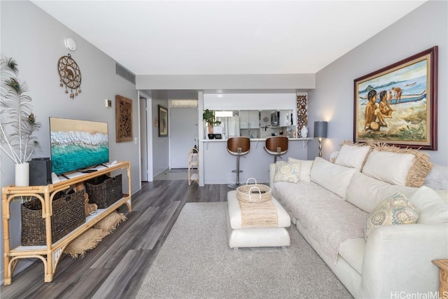 living area with wood finished floors and visible vents
