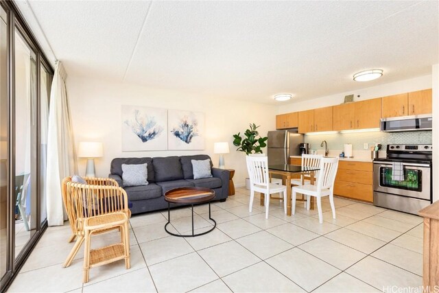 201 Ohua Ave Unit 908, Honolulu, HI 96815 - living room with light tile patterned floors and a textured ceiling