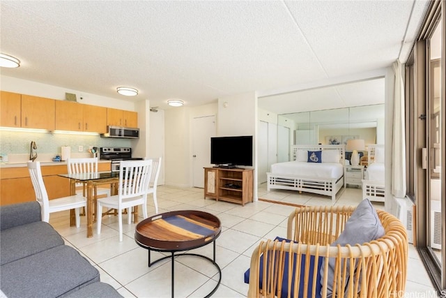 201 Ohua Ave Unit 908, Honolulu, HI 96815 - living room featuring a textured ceiling and light tile patterned floors