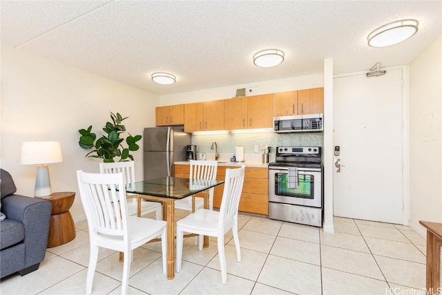 201 Ohua Ave Unit 908, Honolulu, HI 96815 - kitchen with light tile patterned flooring, light countertops, a sink, tasteful backsplash, and appliances with stainless steel finishes