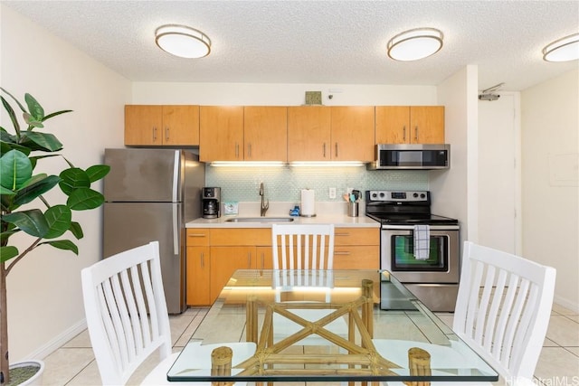 201 Ohua Ave Unit 908, Honolulu, HI 96815 - kitchen with light tile patterned flooring, light countertops, a sink, tasteful backsplash, and stainless steel appliances