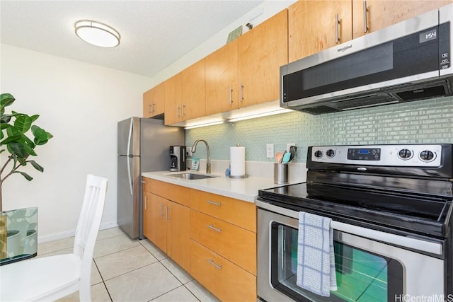 201 Ohua Ave Unit 908, Honolulu, HI 96815 - kitchen with light countertops, stainless steel appliances, decorative backsplash, a sink, and light tile patterned flooring