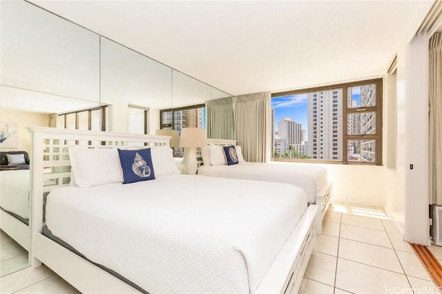 201 Ohua Ave Unit 908, Honolulu, HI 96815 - bedroom featuring a view of city and light tile patterned floors