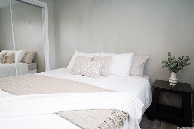 bedroom with a closet and wood finished floors