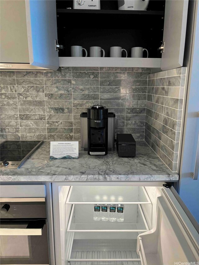 383 Kalaimoku St Unit 1106, Honolulu, HI 96815 - kitchen view of backsplash, black electric stovetop, and open shelves