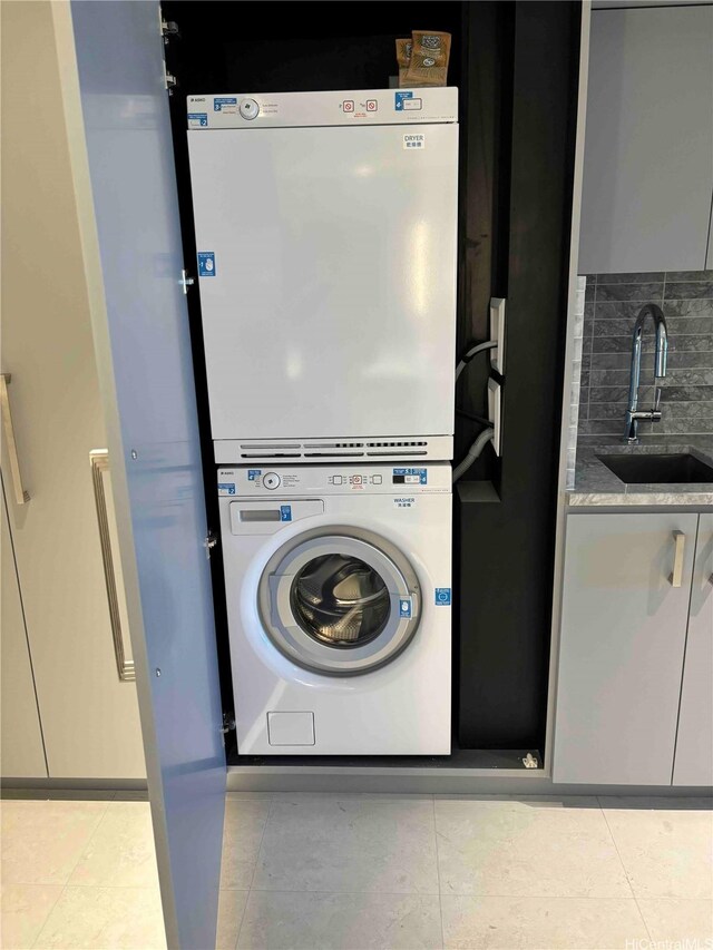 383 Kalaimoku St Unit 1106, Honolulu, HI 96815 - laundry area with stacked washer / drying machine and light tile patterned floors