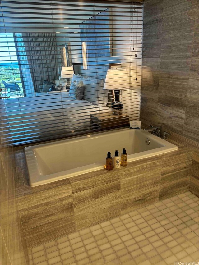383 Kalaimoku St Unit 1106, Honolulu, HI 96815 - bathroom with a bath, tile patterned flooring, and tile walls