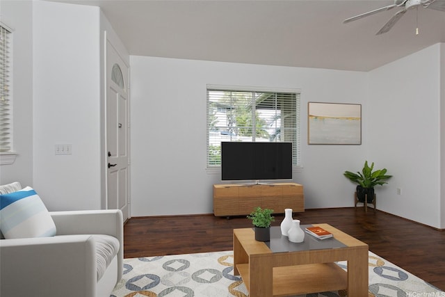 living area with a ceiling fan and wood finished floors