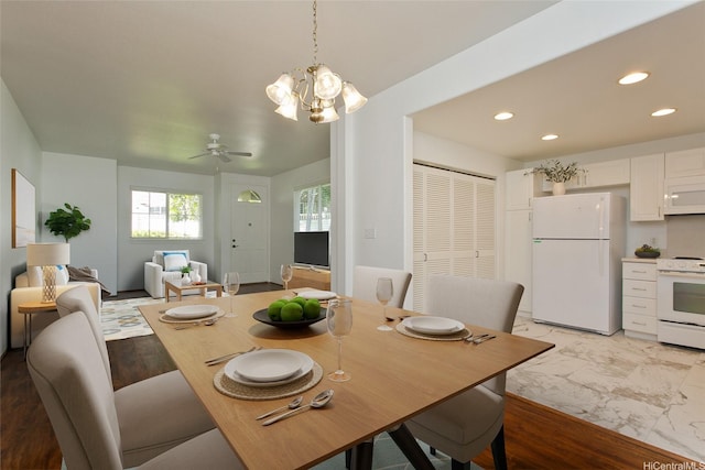 dining area with marble finish floor, ceiling fan with notable chandelier, and recessed lighting