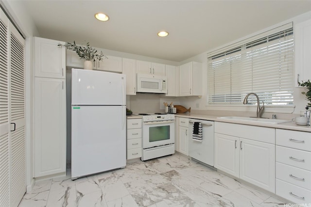 kitchen featuring white cabinets, marble finish floor, a sink, and white appliances