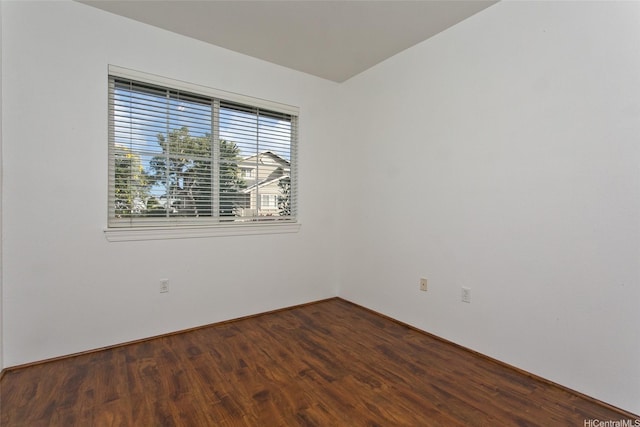 unfurnished room featuring dark wood-style flooring