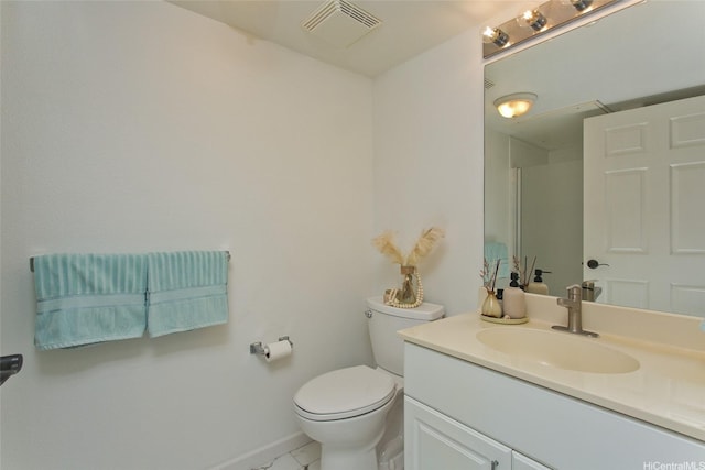 bathroom featuring baseboards, visible vents, vanity, and toilet