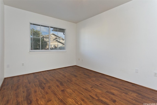 spare room with wood finished floors