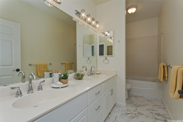 full bath with double vanity, marble finish floor, toilet, and a sink