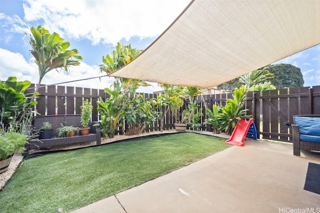 view of yard featuring a patio area and a fenced backyard