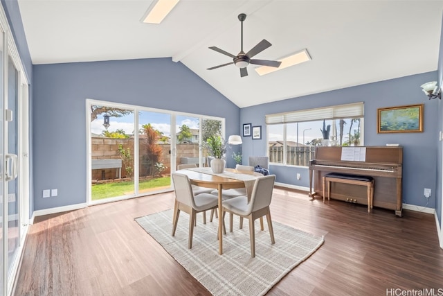 dining room featuring baseboards, ceiling fan, wood finished floors, and beam ceiling
