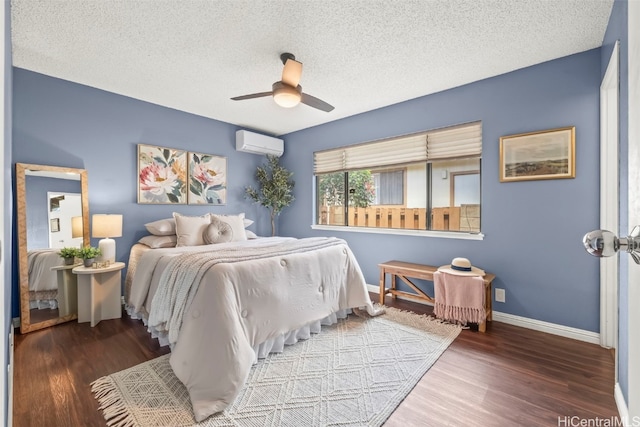 bedroom featuring wood finished floors, a wall mounted air conditioner, and a textured ceiling