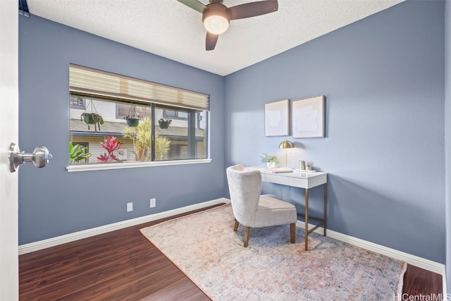 office featuring baseboards, wood finished floors, ceiling fan, and a textured ceiling