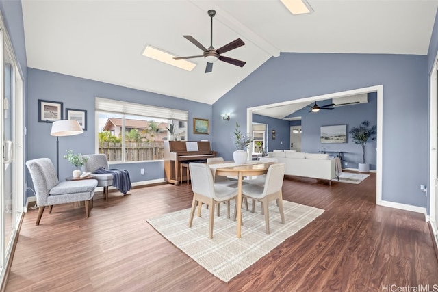 dining space with baseboards, lofted ceiling with beams, wood finished floors, and ceiling fan