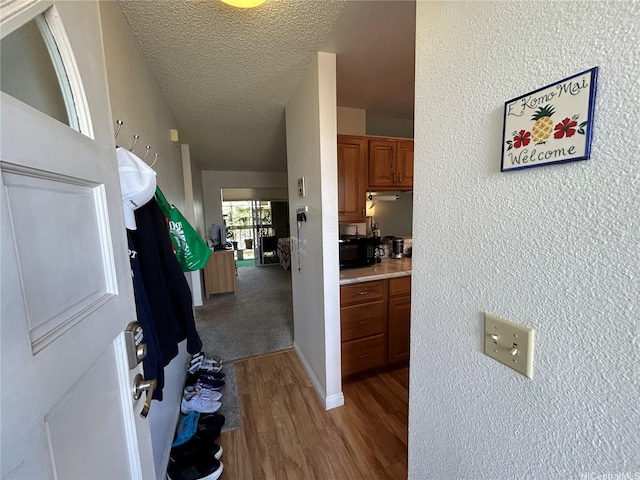 94-203 Paioa Pl Unit P201, Waipahu, HI 96797 - hallway with wood finished floors and a textured ceiling