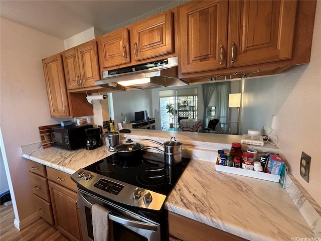 94-203 Paioa Pl Unit P201, Waipahu, HI 96797 - kitchen featuring stainless steel electric stove, under cabinet range hood, black microwave, and brown cabinetry